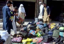 Vendor selling and displaying school bags to attract the customers at Hashtnagri Chowk