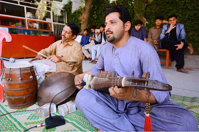 Artists performing on traditional musical instrument Rabab during Spring Festival at PMDC Boys Dalazak road