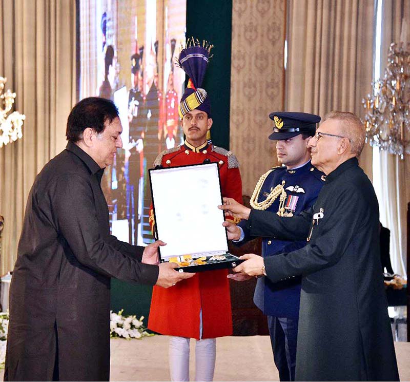 President Dr. Arif Alvi conferring the Pakistan Civil Award of Nishan-i-Imtiaz upon Muhammad Qavi Khan (late) in recognition of his services in the field of Performing Arts (Drama, film & stage) at the Investiture Ceremony on Pakistan Day, held at Aiwan-e-Sadr. His award is being received by Sohail Ahmad