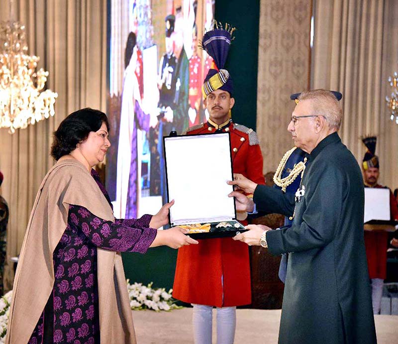 President Dr. Arif Alvi conferring the Pakistan Civil Award of Nishan-i-Imtiaz upon Ahmed Ghulam Ali Chagla (late) in recognition of his services in the field of Art (Musician/Composer) at the Investiture Ceremony on Pakistan Day, held at Aiwan-e-Sadr. His award is being received by the Secretary Ministry of Information and Broadcasting, Ms. Shahera Shahid