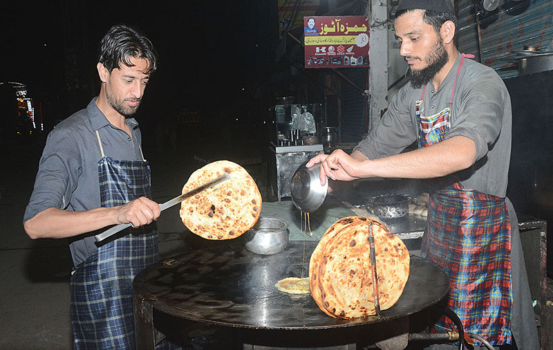 Vendors preparing traditional food stuffed (Parathas) for Sehri at a local market during Holy Fasting Month of Ramzan Ul Mubarak