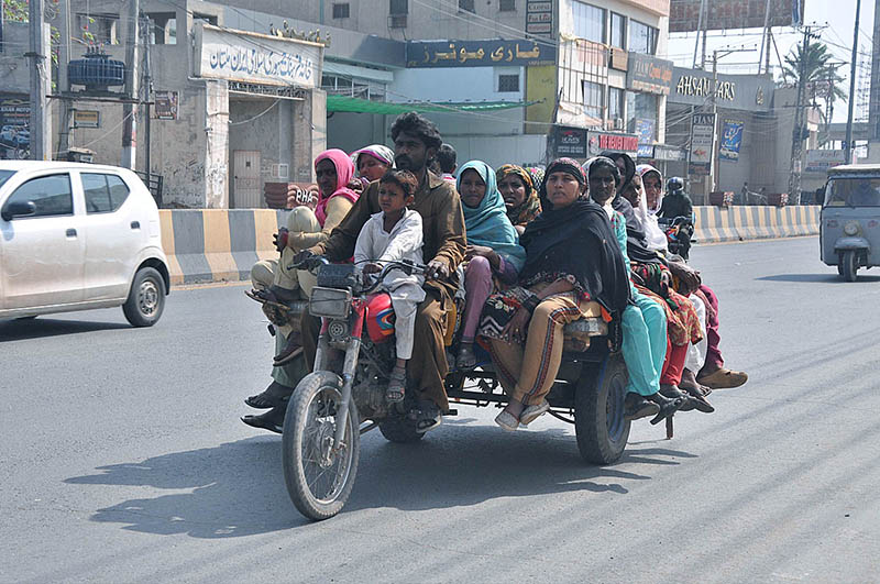 Gypse family traveling on the tricycle rickshaw heading towards their destination