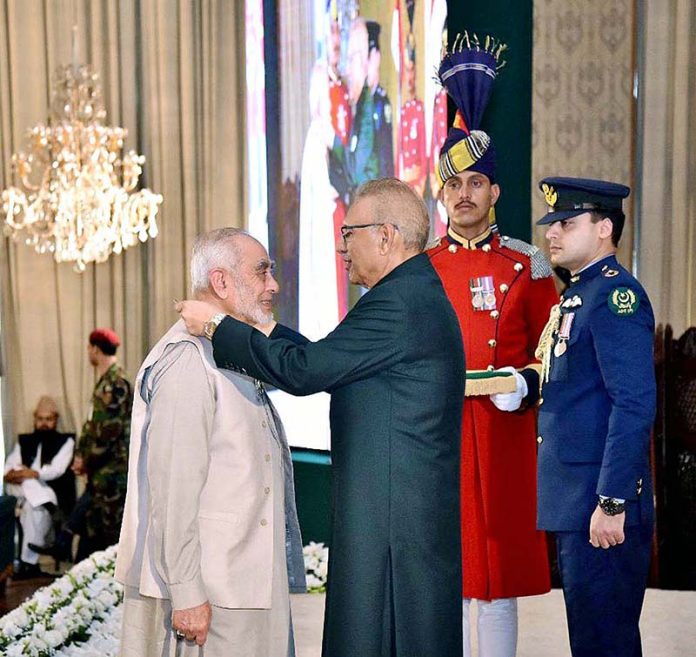 President Dr. Arif Alvi conferring the Pakistan Civil Award of Sitara-i-Imtiaz upon Dr. Anees Ahmed in recognition of his services as a Religious Scholar at the Investiture Ceremony on Pakistan Day, held at Aiwan-e-Sadr