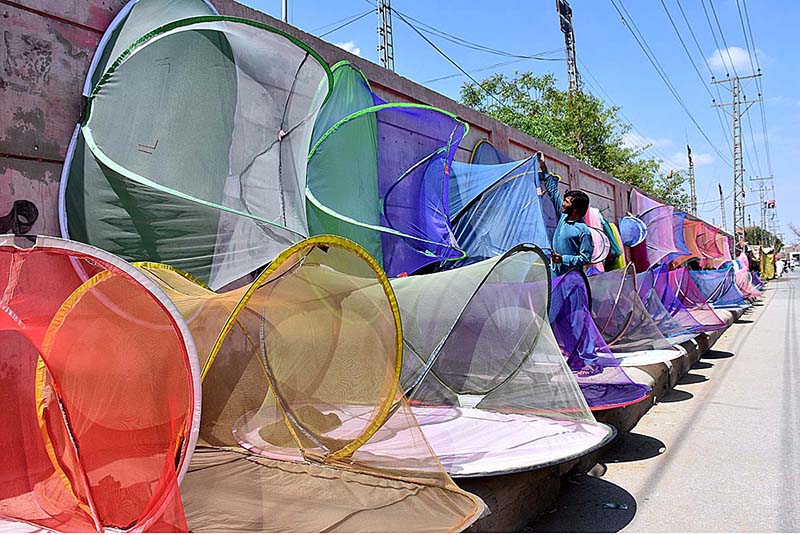A vendor displaying mosquito protective nets to attract the customers at Municipal Stadium Road.