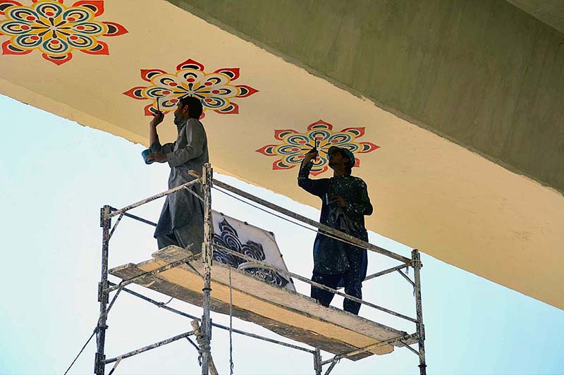 PDA workers are painting and whitewashing Hayatabad Flyover