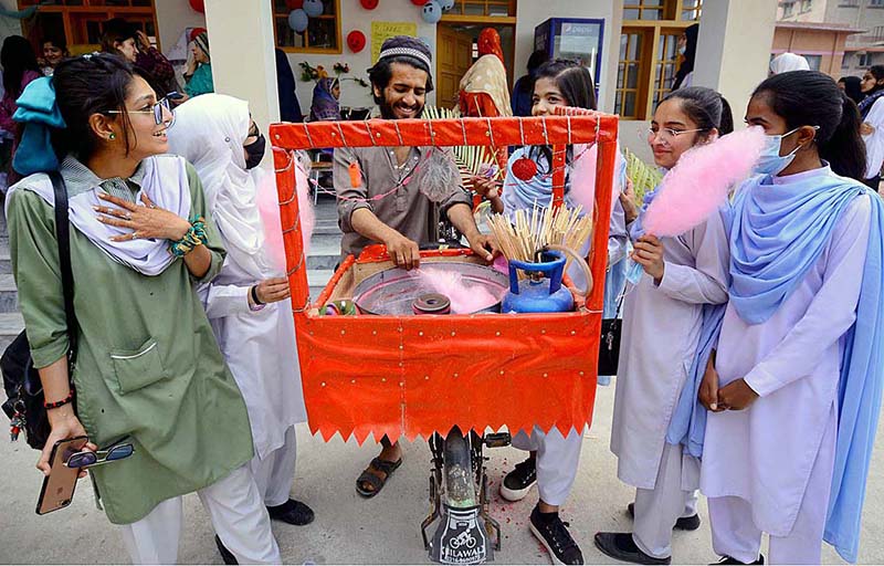 Vendor preparing cotton candy for school girls during Jashn-e-Baharan Sports Festival at Government City Girls College