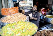 A vendor is selling sweets food items in connection with Shab-e-Barat at Gawalmandi