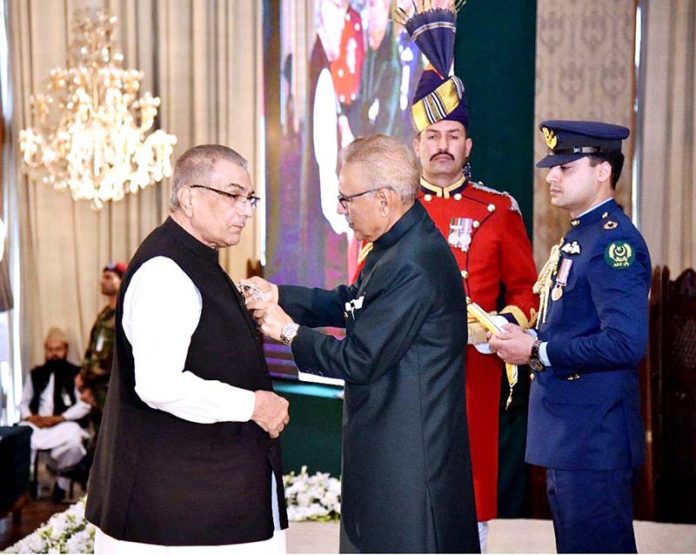 President Dr. Arif Alvi conferring the Pakistan Civil Award of Hilal-i-Imtiaz upon Mujib-ur-Rahman Shami in recognition of his services in the field of Journalism at the Investiture Ceremony on Pakistan Day, held at Aiwan-e-Sadr