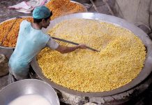 A worker busy in frying traditional food item (Pakoriyaa) mostly used in Dahi Bhalle during the holy fasting month of Ramzan