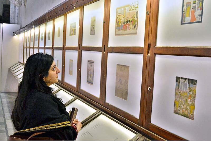 Visitors viewing displayed artworks at Lahore Museum