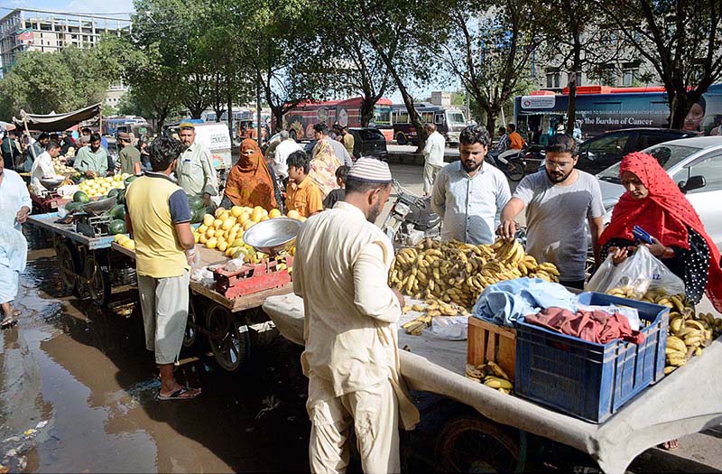 People busy in purchasing fresh fruits from vendors on the first day of holy month of Ramazan