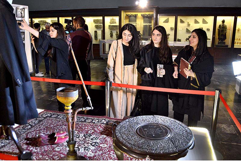 Visitors viewing displayed artworks at Lahore Museum