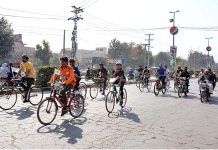 Deputy Commissioner Ali Annan Qamar reaching Iqbal Stadium by riding his bicycle in connection with the Jashan Baharan celebrations organized by the district administration