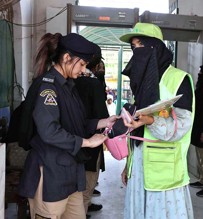 Security official checking the devotees on the entrance point at the shrine of Hazrat lal Shahbaz Qalandar during 771st Urs celebration