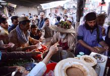 View of a large number of customers purchasing sweet, sour and spicy sauces from a vendor during the Holy fasting month of Ramzan-Ul-Mubarak here at Qisa Khuwani Bazar