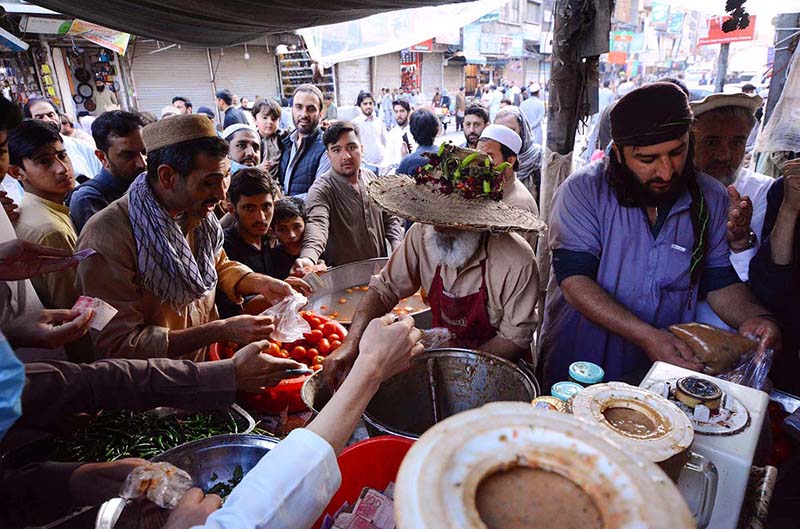 View of a large number of customers purchasing sweet, sour and spicy sauces from a vendor during the Holy fasting month of Ramzan-Ul-Mubarak here at Qisa Khuwani Bazar