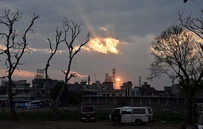 Beautiful view of sunset with rays breaking through thick clouds