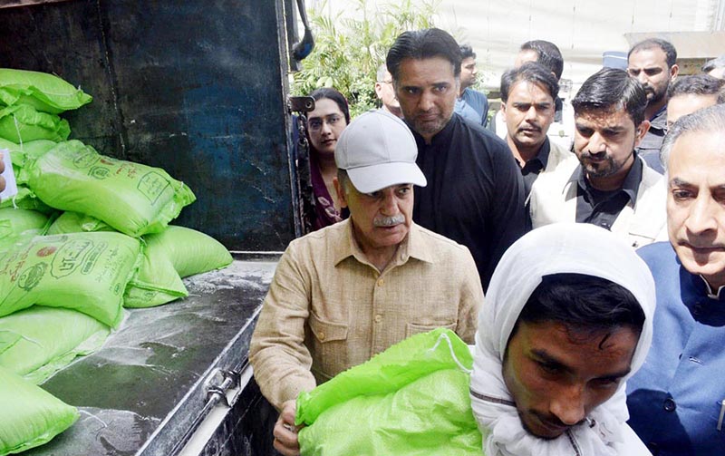 Prime Minister Muhammad Shehbaz Sharif distributes free Atta (Flour) among the beneficiaries of Free Atta Scheme