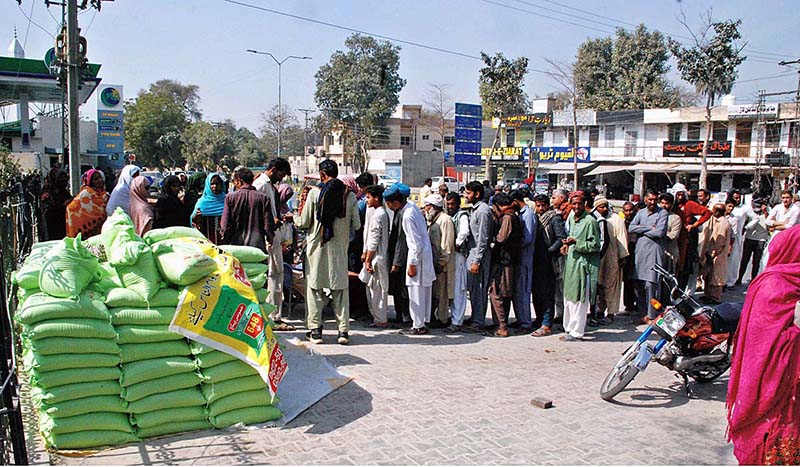 A large number of people in queue to get flour on government subsidized rate from a stall along the roadside