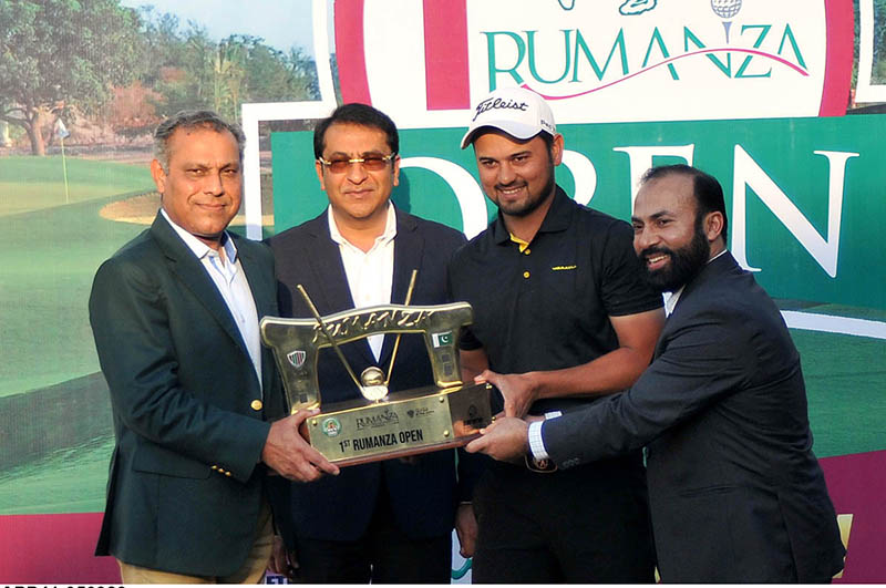 President Golf and country club rumanza giving trophy to the winner of first rumanza open golfing skills and nail- biting competition at Rumanza