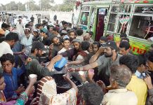 Volunteers distributing sweet drink among people at Iftar organized by Saylani Welfare at Numaish area