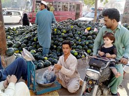 A vendor is selling and displaying watermelons on his roadside setup during holy month of Ramazan ul Mubarak in the Provincial Capital