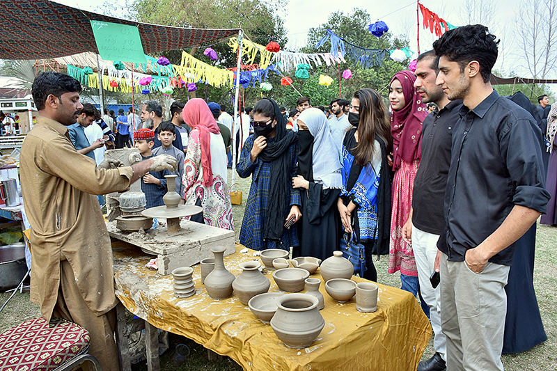 Students are visiting different cultural stalls during Gur Mela at the University of Agriculture Faisalabad as part of spring festival