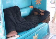 A rickshaw driver sleeping during sunny day