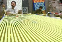 Skilled persons are knitting the traditional bed (Charpai) and Stools for customers at their workplace