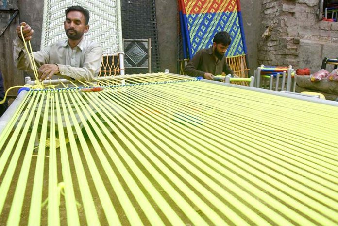 Skilled persons are knitting the traditional bed (Charpai) and Stools for customers at their workplace
