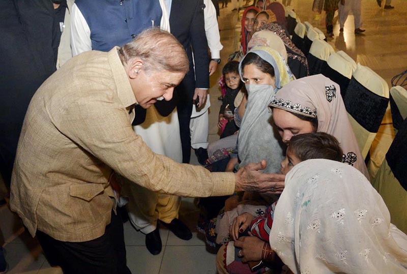 Prime Minister Muhammad Shehbaz Sharif interacts with the beneficiaries of Free Atta Scheme