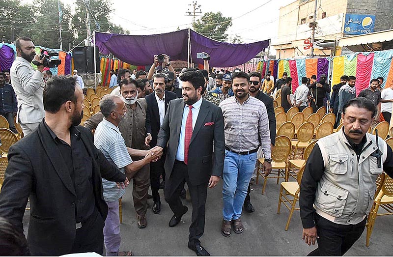 Governor of Sindh Kamran Khan Tessori shaking hands with a civilian during his visit to Barber Market of Landhi