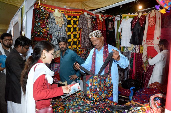 A girl visiting a stall established in 6th Sindh Literature Festival (SLF) at Arts Council of Pakistan