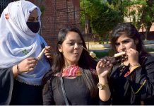 Student eating traditional ice cream “Kolfa” at the Cultural Day Event at Murray College
