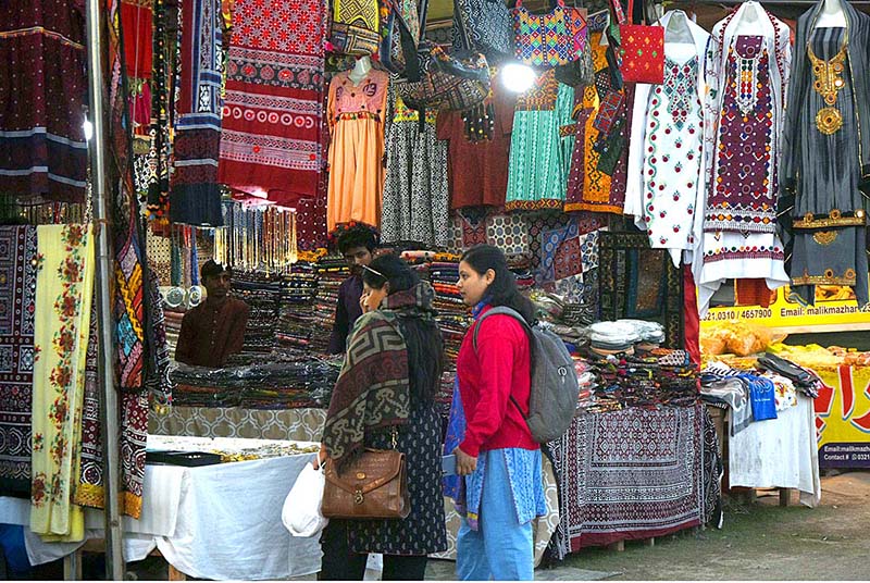 Vendor displaying the Traditional handmade garments to attract the customers during Jashan-e-Baharan Festival at Jillani Park organized by PHA