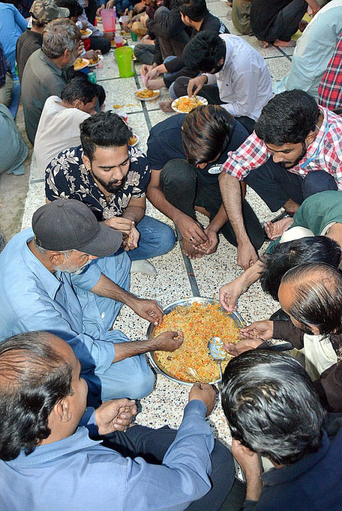 A view of people breaking their fast at iftar time during holy Ramadan near Shadman Chowk