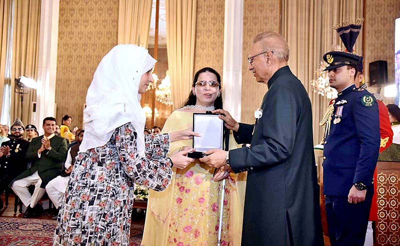 President Dr. Arif Alvi conferring the Pakistan Civil Award of Tamgha-i-Imtiaz upon Ms. Saima Saleem in recognition of her services in the field of Public Service at the Investiture Ceremony on Pakistan Day, held at Aiwan-e-Sadr