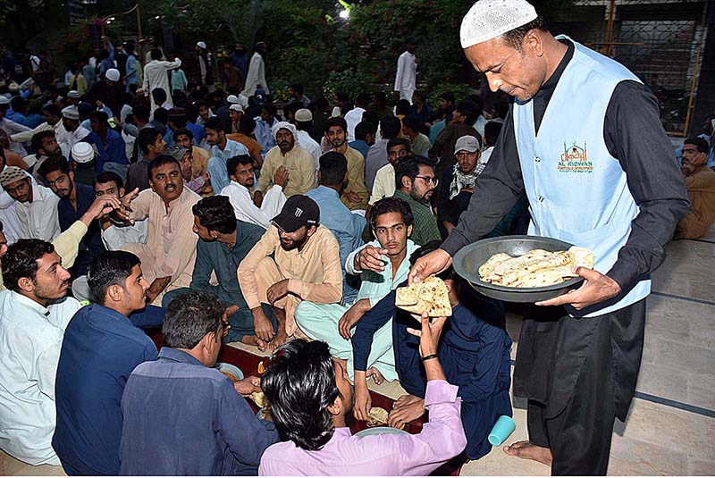 A volunteer busy in arranging iftar food during Holy month of Ramzan at Jamia Muhammadi Masjid near Sheikh Zayed Chowk