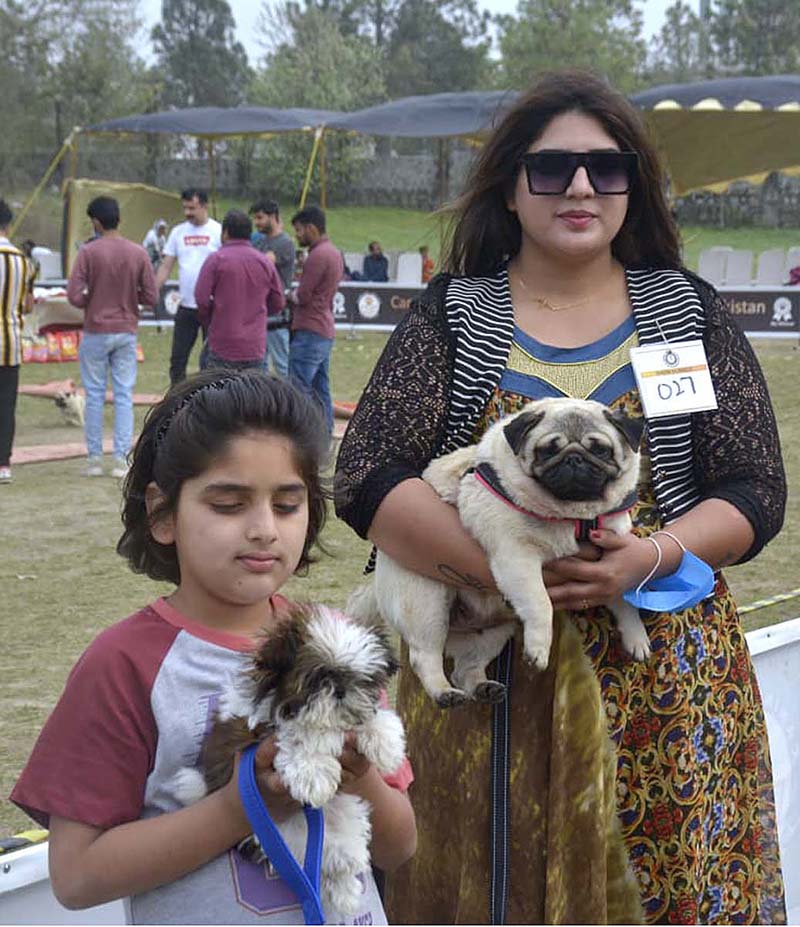 Family along with their Dogs during the International All-breed Championship Dog Show organized by Canine Union Pakistan at F9 Park