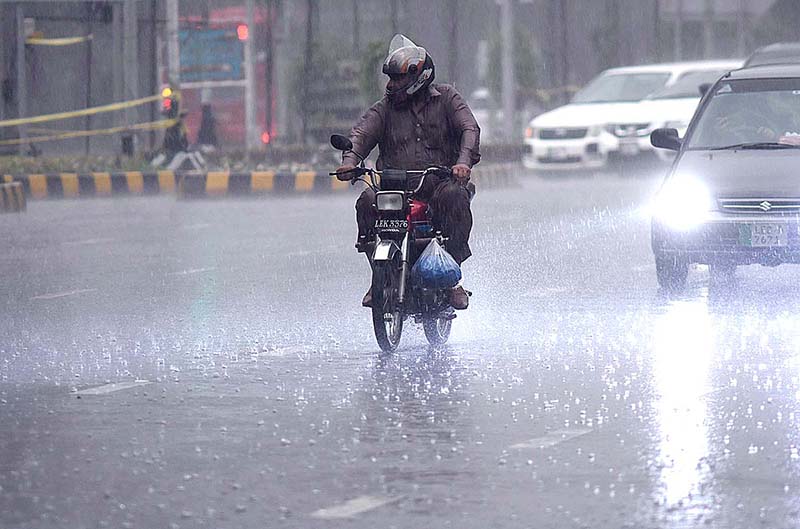 An old man on his bike moving towards his destination during heavy rain in the Provincial Capital