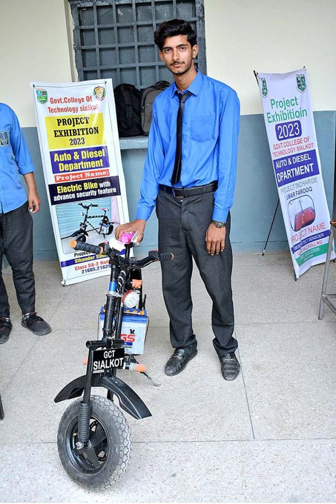 A group photo of students on their project Auto Bridge in the exhibition at Government College of Technology