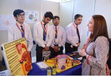 Students stand with their science project at the science fair exhibition held at FC College, foreigners are also visiting and taking their interest the scientific skills of the students