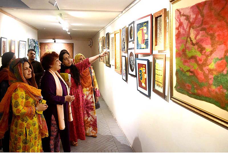 Visitor viewing the displayed stuff during Art Exhibition (Paarcha Baaf) of different Universities including "Punjab University, National College of Arts, Sargodha University, Lahore College for Women University" organized by Pakistan National Council of Arts at Shakir Ali Museum