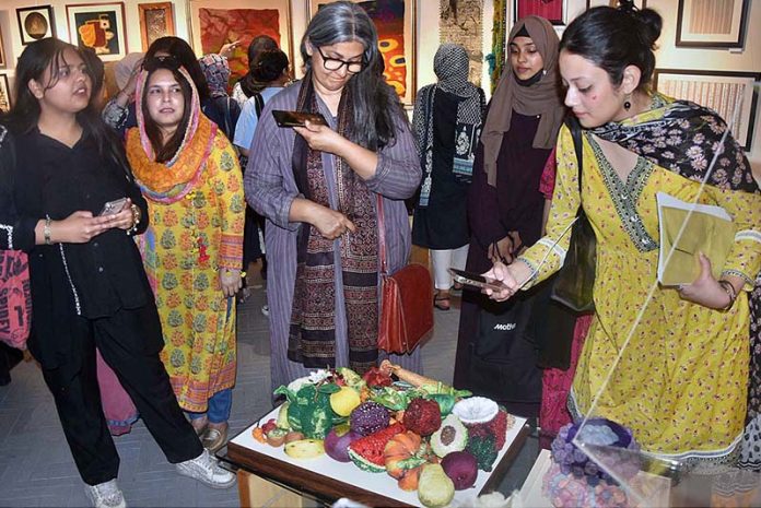 Visitors viewing the displayed stuff during Art Exhibition (Paarcha Baaf) of different Universities including 