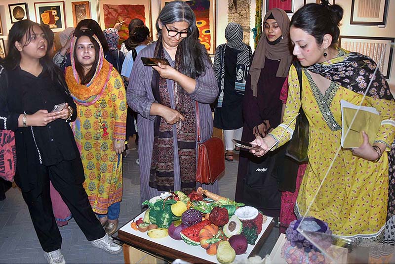 Visitors viewing the displayed stuff during Art Exhibition (Paarcha Baaf) of different Universities including "Punjab University, National College of Arts, Sargodha University, Lahore College for Women University" organized by Pakistan National Council of Arts at Shakir Ali Museum