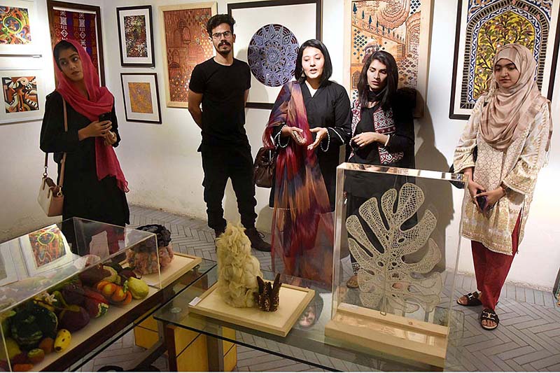 Visitors viewing the displayed stuff during Art Exhibition (Paarcha Baaf) of different Universities including "Punjab University, National College of Arts, Sargodha University, Lahore College for Women University" organized by Pakistan National Council of Arts at Shakir Ali Museum