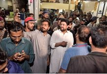 Governor Sindh Kamran Khan Tesori poses for a selfie with a young man at the Burns Road Food Street