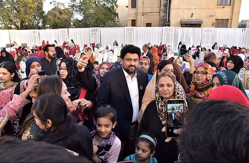 Women taking photo with Governor Sindh Kamran Khan Tesori during Dawat-e-Iftar at the Governor House