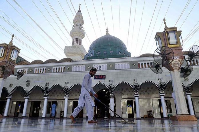 A man clean Masjid e Khizra at Sindh high court ahead of the Holy Islamic fasting month of Ramadan