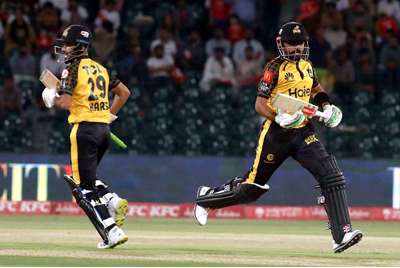 Peshawar Zalmi players Babar Azam and Haris running between the wicket during the Pakistan Super League (PSL) Twenty20 cricket match between Peshawar Zalmi and Islamabad United at the Gaddafi Cricket Stadium